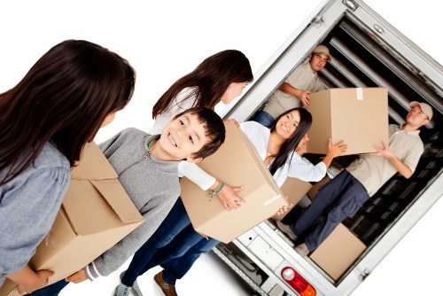 Moving van and crew loading household items for a booked service