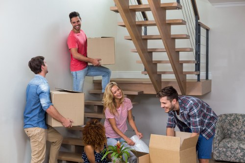 Workers loading a van safely with careful handling procedures