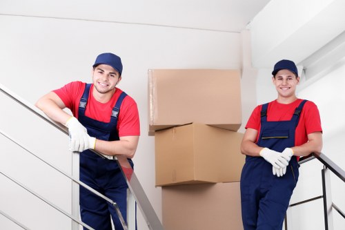 Local movers carrying furniture through a North London residential street