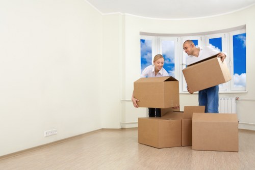 Staff packing computers and office supplies for relocation