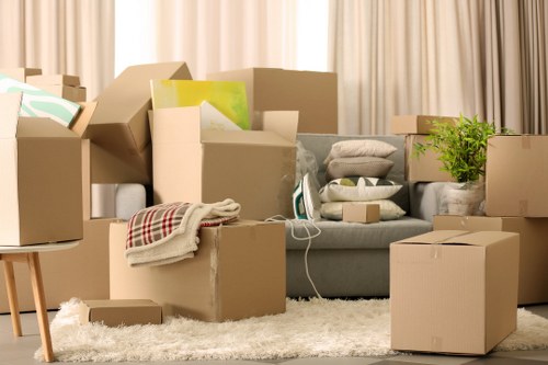 Professional movers carrying furniture through a North London property