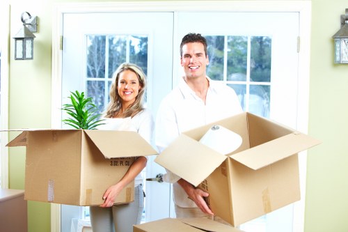 Movers carrying furniture through a Finsbury Park property entrance